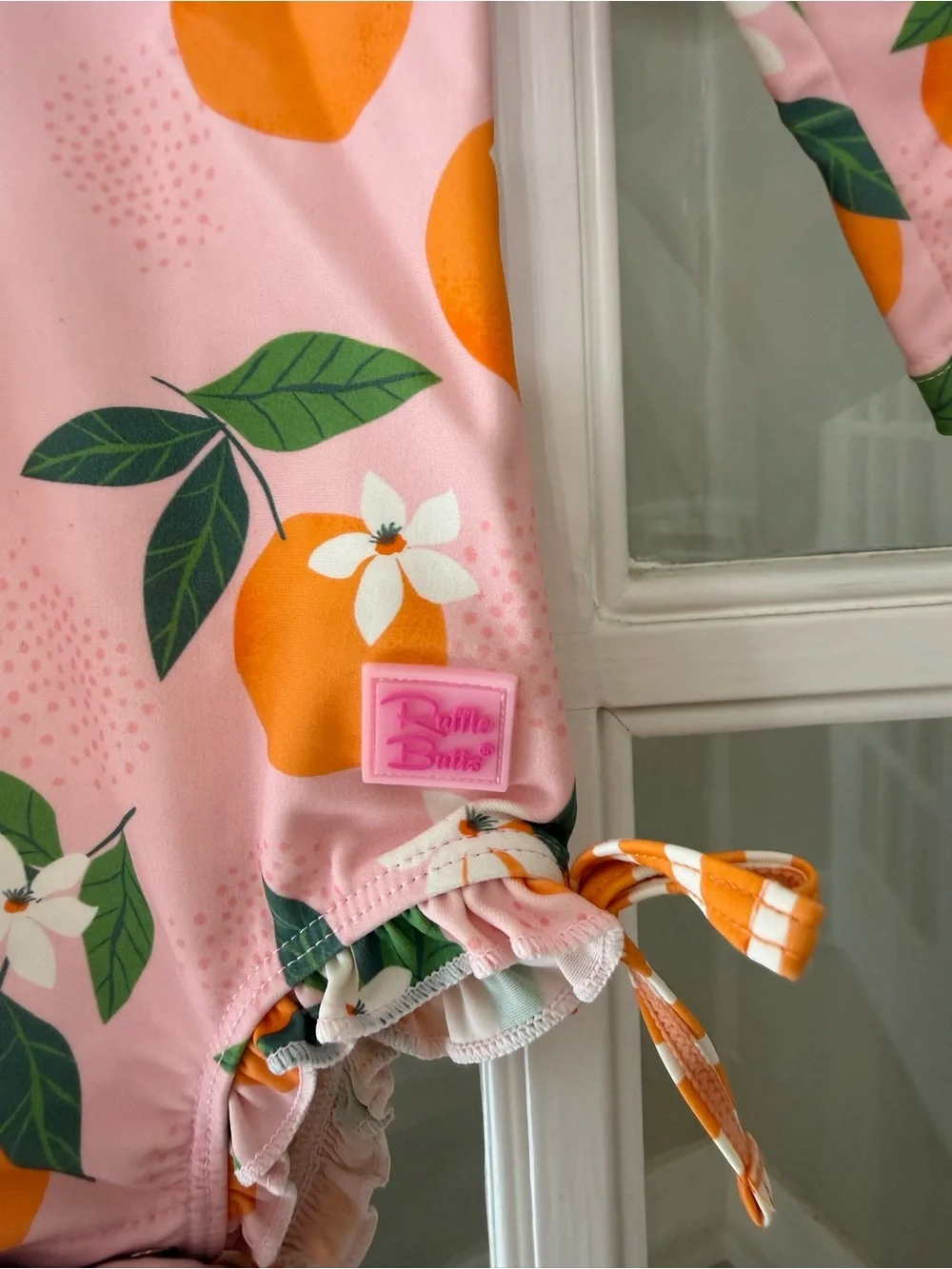 Ruffle Butts Pink Swimsuit with Orange Fruit Print